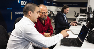 team members looking at laptop