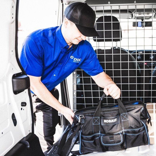 DOC technician returning supplies to his vehicle