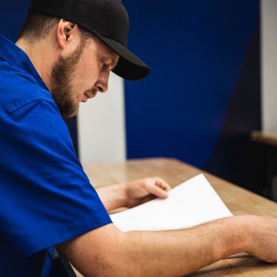 technician reviewing materials