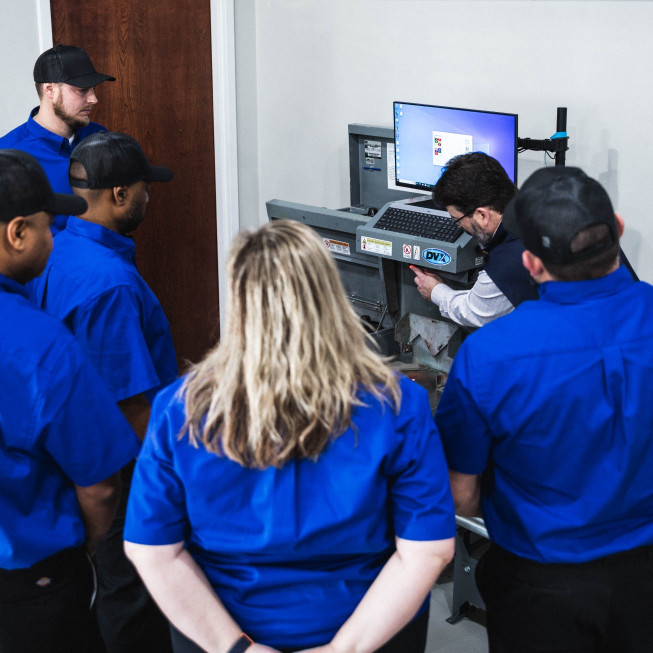 technicians receiving paint automation demo at DOC Services training center