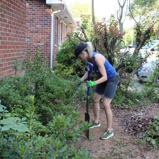 volunteer working on garden outside of Habitat for Humanity house