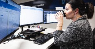 employee drinking coffee at desk