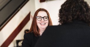 vendor smiling while meeting with employee