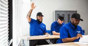 technician raising his hand with question while learning at the training center