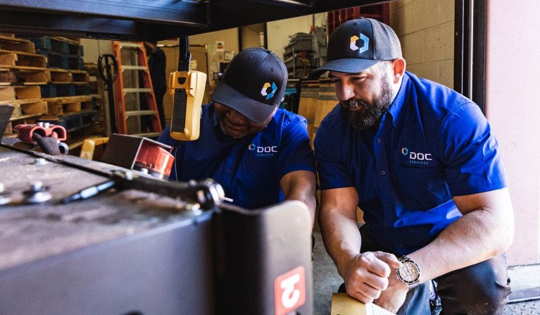 DOC Services technicians working on equipment