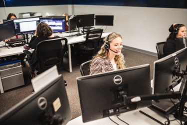 call center employees smiling while working together