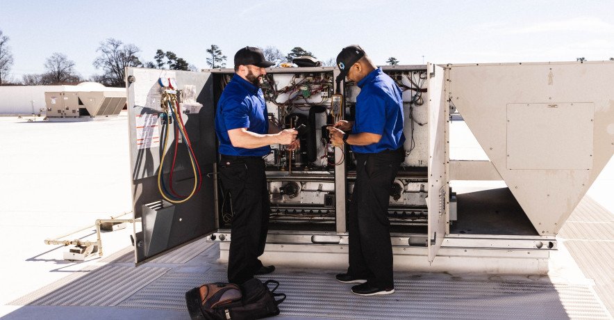 DOC Services employees working together to fix equipment